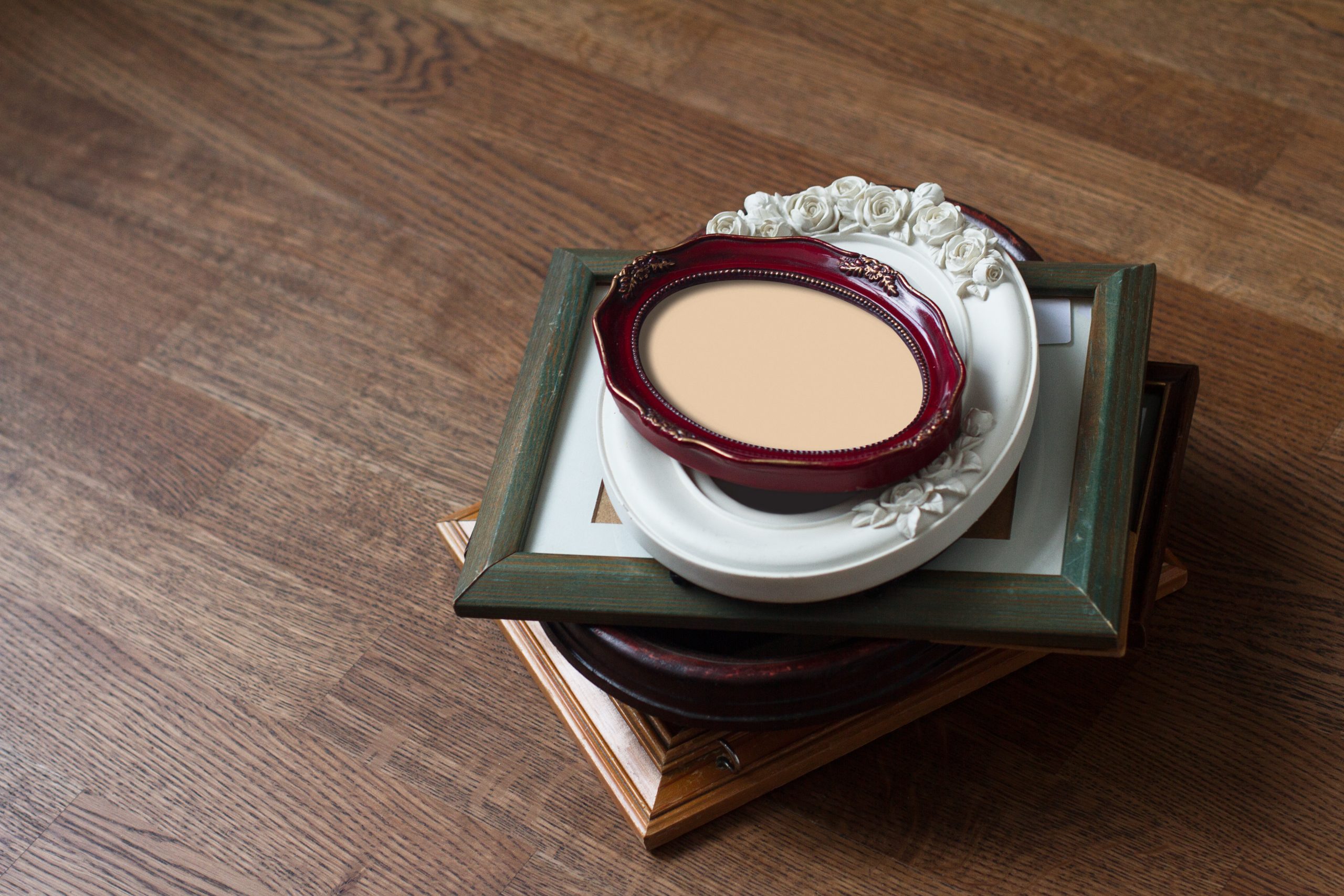 perspective view of stack wood vintage frames of all shapes colors and seizes on dark brown wooden parquet floor background